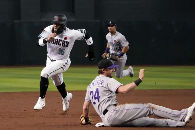 May 29, 2023; Phoenix, AZ, USA; Arizona Diamondbacks third baseman Emmanuel Rivera (15) is led by Colorado Rockies third baseman Ryan McMahon (24), Scored at Chase Field in the second inning.